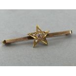 9ct Gold hallmarked tie pin set with an 18ct hallmarked star with central diamond and five