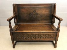 Carved oak folding monks bench with hinged seat, approx 106cm in length