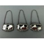 Three hallmarked Silver matching bottle labels, Whisky, Brandy & Sherry on chains