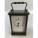 Small brass carriage clock with ceramic dial approx 11cm tall