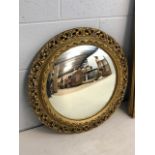 Porthole style mirror with ornate gilt frame, approx 60cm in diameter