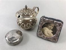 Silver pill box with original liner, hallmarked London 1929, a small silver photo frame and a sliver