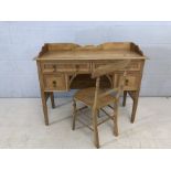 Small antique pine desk with four drawers and upstand, matching brass handles, accompanied by pine