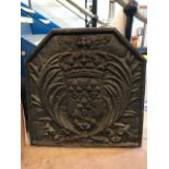 Cast iron fire back with shield and crown design, approx 58cm tall x 57cm wide x 4cm deep