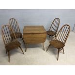 Blonde Ercol Dining table and four stick back chairs