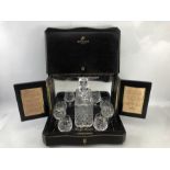 Vintage Remy Martin cognac cabinet with a cut glass decanter and four cut glass brandy glasses.