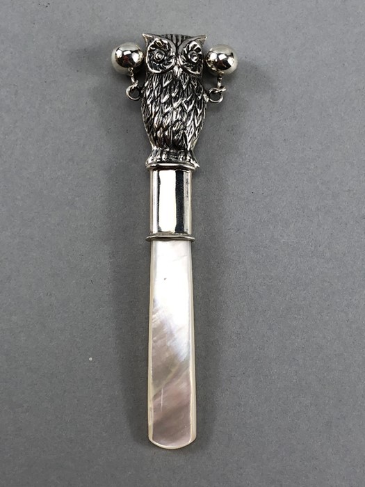 Silver babies rattle with mother of pearl handle