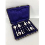 Set of Hallmarked Silver teaspoon and sugar nips in original purple velvet lined case