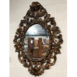 Large oval Rococo style mirror with ornate frame, approx 100cm tall x 74cm wide