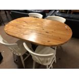 Oval pine kitchen table with painted base and four matching painted pine spindle back chairs