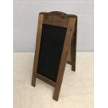 French wooden A-frame sign for 'Les Gourmands Chocolatier Confiserie' with blackboard inserts on