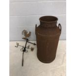 Vintage rusty milk churn and a cockerel weather vane