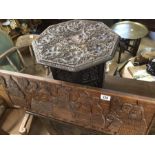 Two carved wooden items to include a folding side table with leaf decoration and a carved wooden