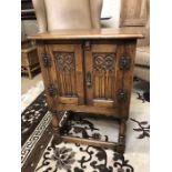 Small oak cupboard with carved detailing