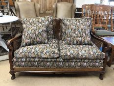 Early 20th Century cane-backed two seater Bergere sofa with upholstered cushions