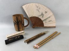 Chinese writing set in a bamboo mug to include bamboo tip pens, cased ink block and a folding fan