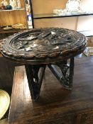 Eastern circular side table with elephant detailing to legs and heavily carved top, approx 62cm in