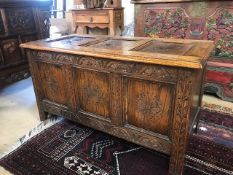 Carved oak coffer with three panel detailing, approx 107cm x 51cm x 59cm tall