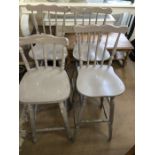 Four tall painted bar stools in a shabby chic style