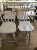 Four tall painted bar stools in a shabby chic style