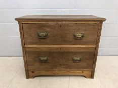 Small low chest of two drawers with brass handles, approx 93cm x 43cm x 77cm tall