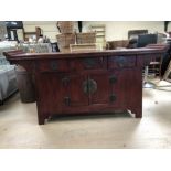 Chinese style sideboard with red and black patina and large metal fixings in the style of an alter