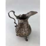 George III hallmarked silver pedestal cream jug with embossed foliate decoration, height approx 10cm