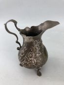 George III hallmarked silver pedestal cream jug with embossed foliate decoration, height approx 10cm