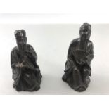 Two Chinese /eastern Bronze seated figurines, one with fan the other with pipes approx 8cm tall