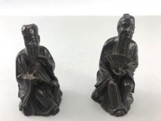 Two Chinese /eastern Bronze seated figurines, one with fan the other with pipes approx 8cm tall