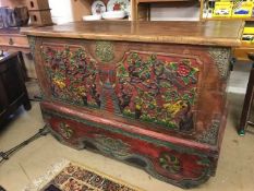 Large Eastern-style chest with heavily carved hand-painted scenes, brass detailing and cast iron