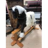Children's upholstered rocking horse on wooden base, approx 84cm tall