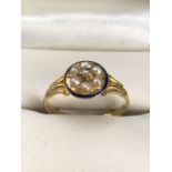 18ct Gold ring in the Revival style with a Blue enamel circular border, inside of which are a ring