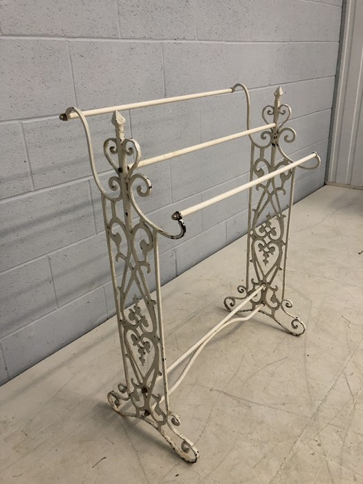 Wrought iron three tiered towel rail with scroll decoration