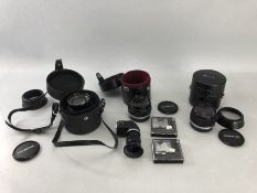 Three Olympus lenses, all with cases, filter and hoods: 24mm F/2.8 Zuiko, 28mm F/3.5 Zuiko, 85mm F/2