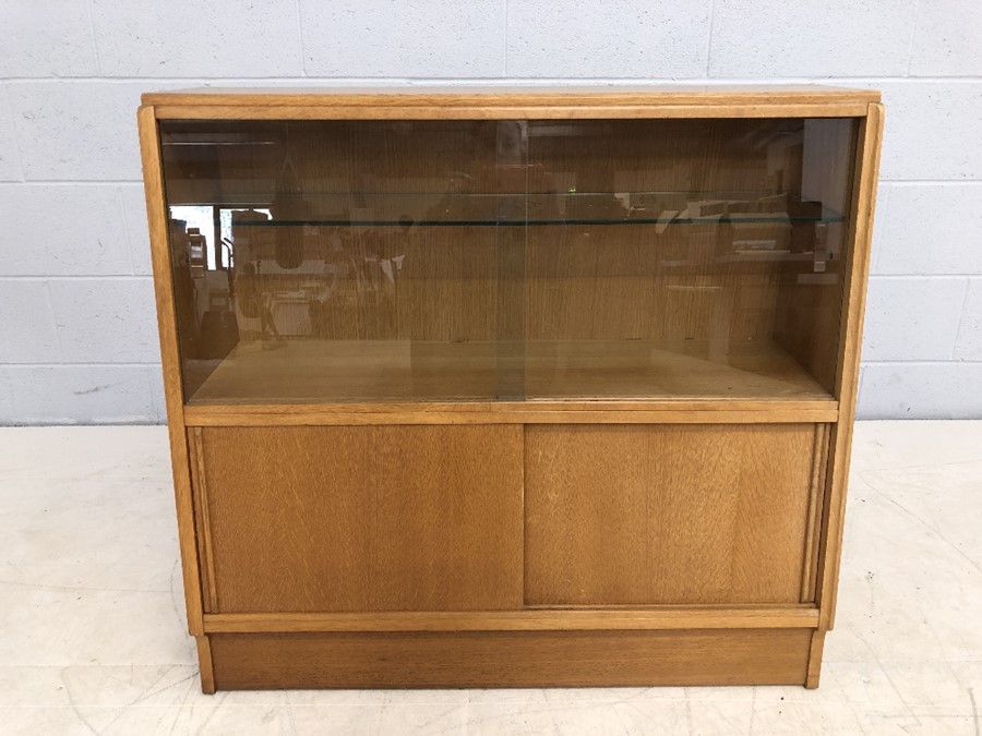 Mid Century G-Plan shelving unit with sliding door cupboards under and glass shelves above, approx