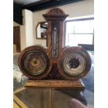 Interestingly shaped clock / barometer / thermometer in a wooden case