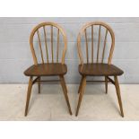 Pair of Ercol stick-back blond chairs