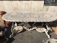 Large ornate painted aluminium outdoor dining table with two pedestal bases, approx 187cm x 95cm x