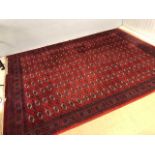 Large red ground carpet with all-over design, approx 300cm x 410cm
