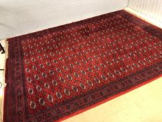 Large red ground carpet with all-over design, approx 300cm x 410cm