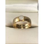 18ct wide Gold band fully hallmarked and set with a Fire Opal approx 5mm Diameter, size 'M'
