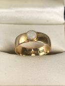 18ct wide Gold band fully hallmarked and set with a Fire Opal approx 5mm Diameter, size 'M'