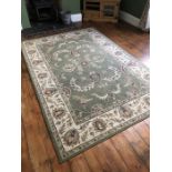 Large green ground rug, approx 294cm x 200cm