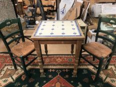 Small pine kitchen table with tile inlay and a pair of rush-seated chairs. Table approx 68cm square