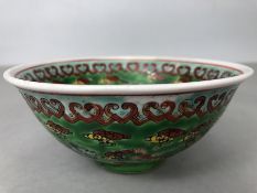 Mid 20th century Chinese bowl on green ground with dragons and flaming pearls red character mark