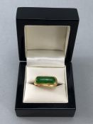 Gold ring marked 9999/6666 and 'SK' set with a large green stone possibly Jade (Chinese) size 'S'