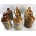 Collection of six vintage cider flagons to include Ernest Green of Leek, Bates Bros of Bolton, Sykes