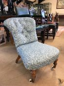 Victorian low upholstered nursing chair with original ceramic and brass castors