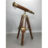Small wooden telescope with brass fittings on tripod stand